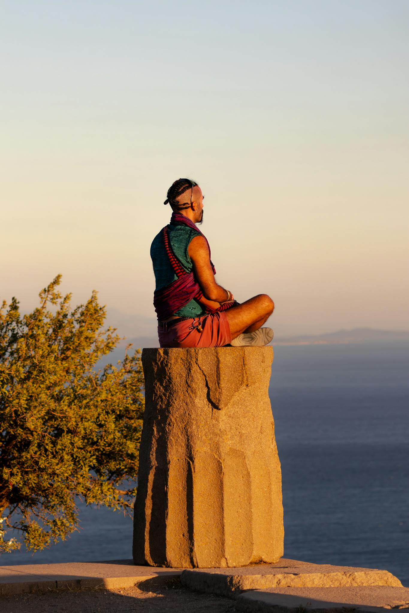 Person meditating on stone pillar overlooking the Aegean Sea in Assos, &Ccedil;anakkale.